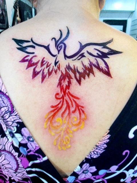 Black, red and yellow phoenix tattoo on the back