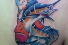 Blue and yellow fish tattoo on the back