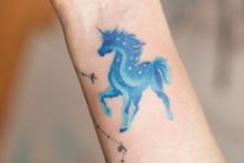 Blue unicorn tattoo on the wrist
