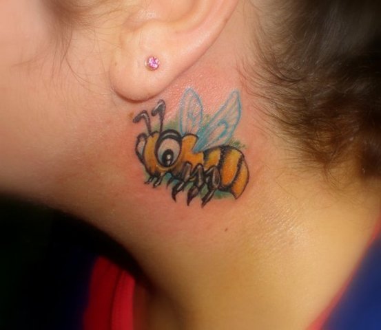 Cartoon bee tattoo behind the ear