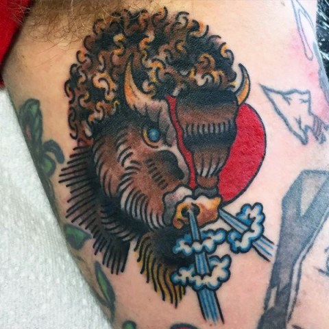 Cartoon bison tattoo on the hand