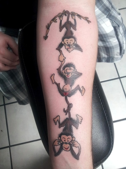 Cartoon monkeys tattoo on the arm