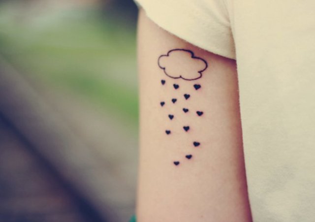 Cloud and hearts tattoo on the hand