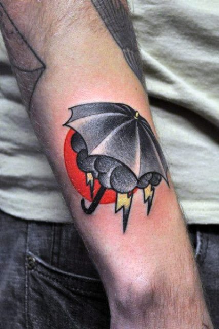 Cloud and umbrella tattoo on the forearm