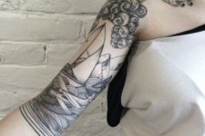 Clouds, ship and planes tattoo on the arm