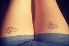 Clouds with sun and thunder tattoos on both legs