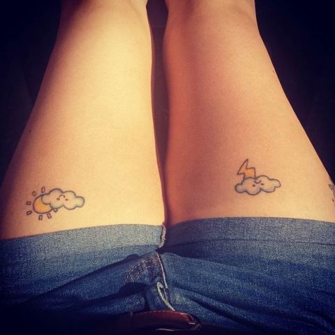 Clouds with sun and thunder tattoos on both legs