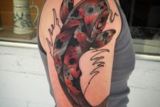 Colorful fish tattoo on the arm