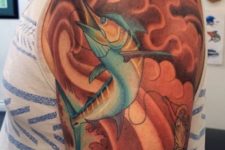 Colorful half-sleeve fishing tattoo