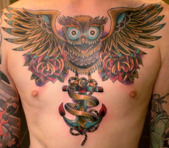 Colorful owl and anchor tattoo on the chest