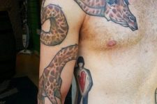 Cool giraffe tattoo on the arm, shoulder and chest