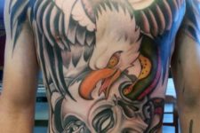 Eagle and scull tattoo on the chest and stomach