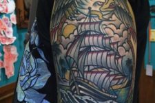 Eagle and ship tattoo on the arm