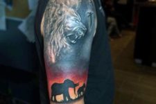Elephant and lion tattoo on the hand