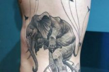 Elephant on wheels tattoo on the side