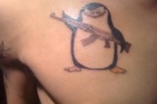 Funny penguin tattoo on the chest