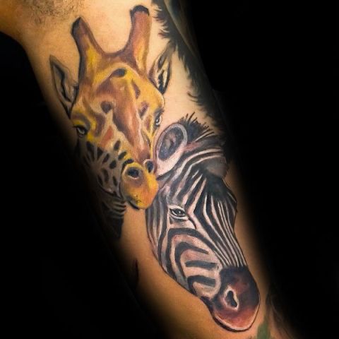 Giraffe and zebra tattoo on the hand