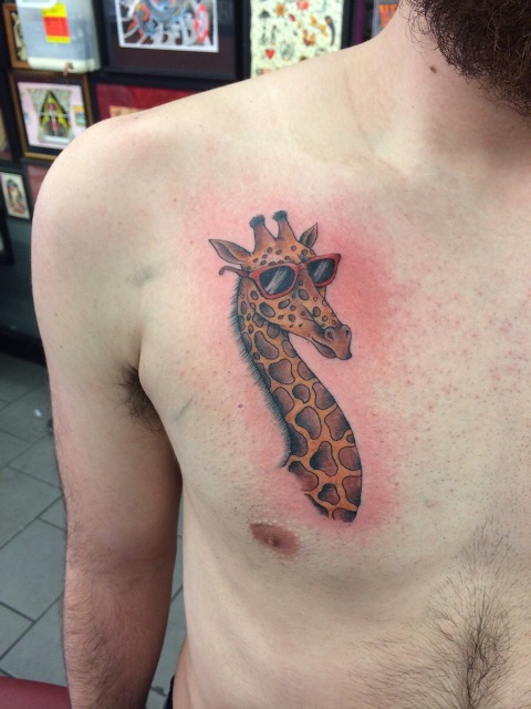 Giraffe with sunglasses tattoo on the chest