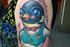 Half-sleeve cartoon penguin tattoo