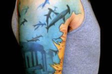 Half-sleeve tattoo with several sharks