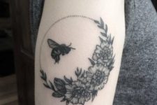Honey bee and flowers tattoo on the arm