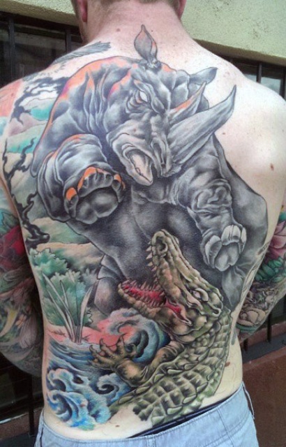 Huge tattoo with alligator on the back