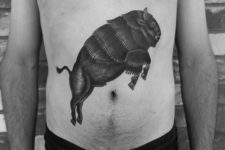Jumping bison tattoo on the stomach