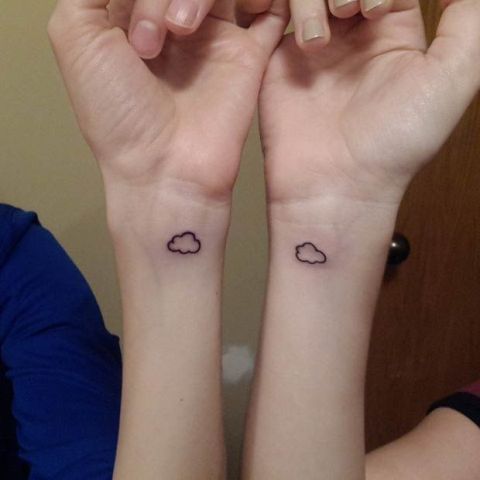 Matching tiny cloud tattoos for friends
