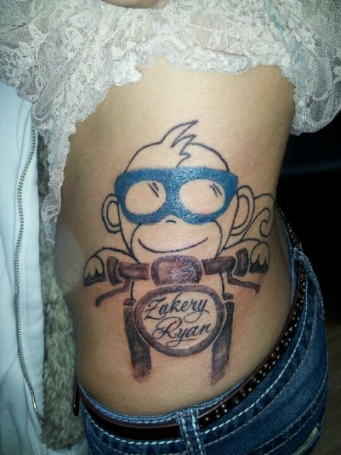 Monkey and motorcycle tattoo on the side