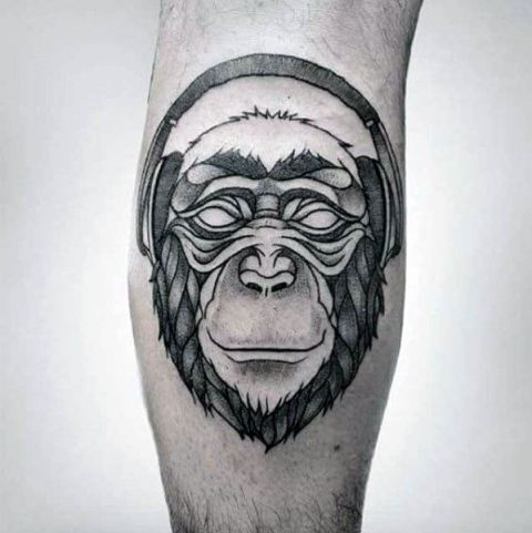 Monkey with headphones tattoo on the leg