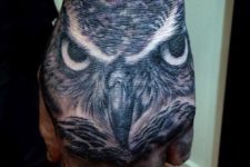 Owl head tattoo on the fist
