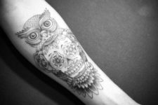 Owl tattoo on the forearm