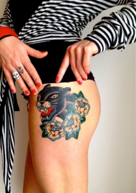 Panther and yellow flowers tattoo on the thigh
