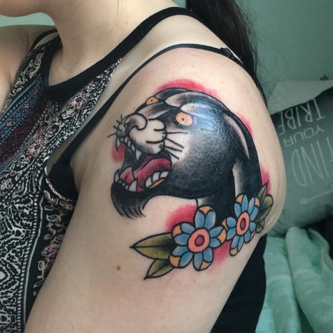 Panther head and blue flowers tattoo