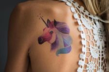 Pastel colored unicorn tattoo on the back