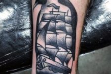 Penguin and ship tattoo on the leg