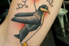 Penguin with balloon tattoo