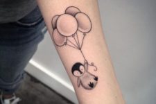 Penguin with balloons tattoo on the arm