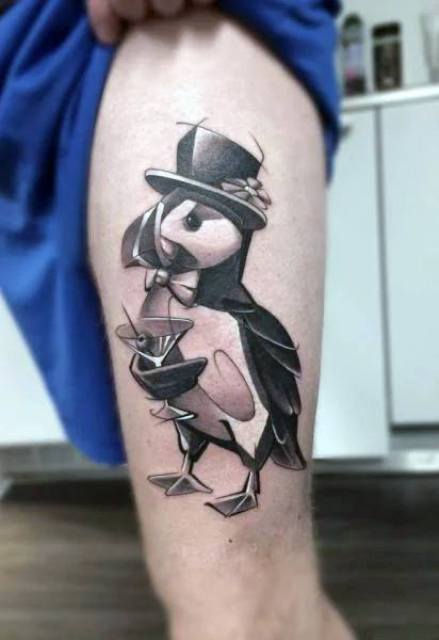 Penguin with cocktail tattoo on the leg
