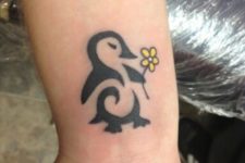Penguin with yellow flower tattoo