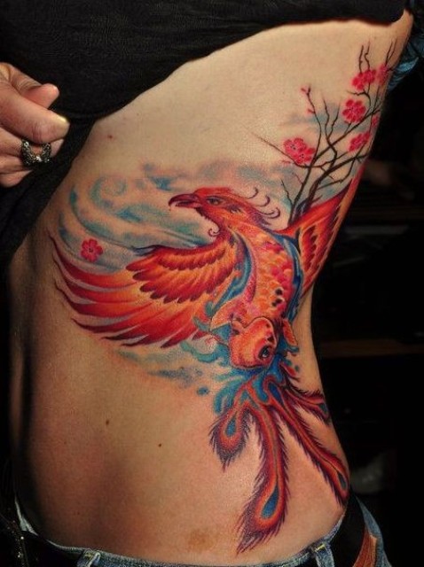 Phoenix and tree tattoo on the side