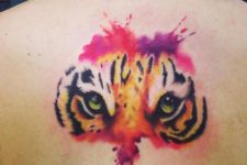 Pink, purple and yellow tattoo on the back