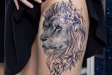 Pretty lion with lilac flowers tattoo on the thigh