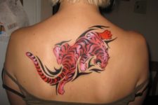 Red and black tiger tattoo on the back