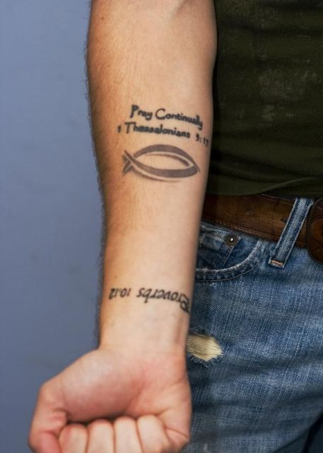Simple fish tattoo on the arm