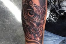 Simple owl tattoo on the arm
