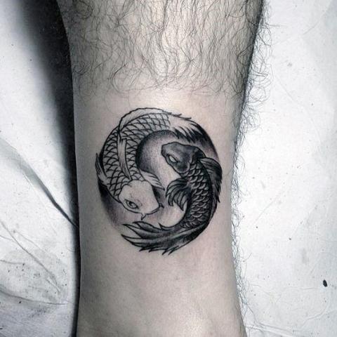 Small Yin Yang fish tattoo on the leg