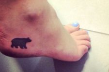 Small black tattoo on the foot