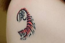 Small tiger tattoo on the shoulder
