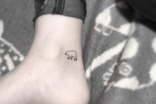Tiny black-contour tattoo on the ankle